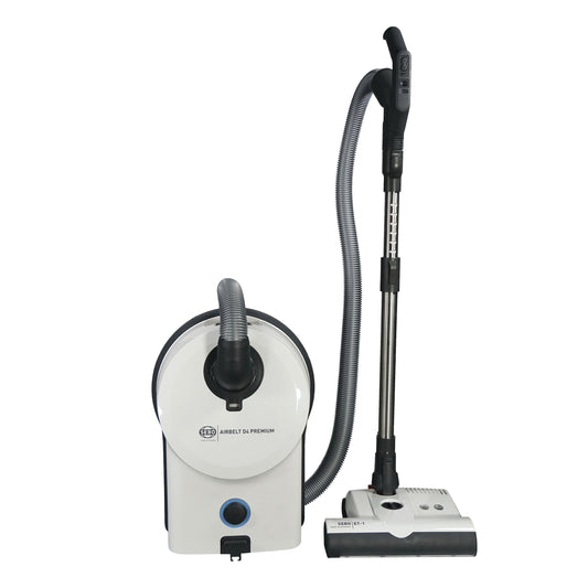 SEBO Airbelt D4 Premium canister vacuum cleaner with a white and gray color scheme, including the main unit, a cleaning head, a crevice nozzle, and a dusting brush.
