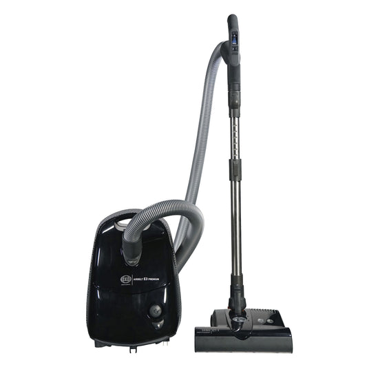 A black SEBO Airbelt E3 canister vacuum with an ET-1 Powerhead and a telescopic wand, displayed alongside its components including a hose and filters.