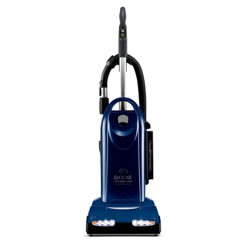 A blue Riccar R40P Tandem Air upright vacuum cleaner with LED lights on the base and a metal handle.